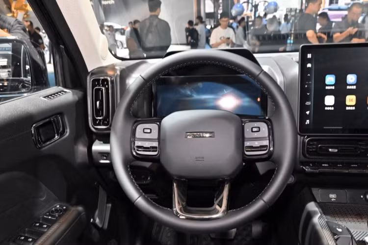 Bước vào bên trong xe, Haval Raptor áp dụng phong cách thiết kế vuông vắn hơn, được trang bị 2 màn hình kích thước lớn, trong đó, bảng đồng hồ full LCD 13,2 inch, màn hình điều khiển trung tâm 14,6 inch dư sức cho các trải nghiệm và W-HUD. Đáng khen là thay vì bỏ các nút vào màn hình cảm ứng 14,6 inch, Haval Raptor vẫn giữ lại nhiều nút bấm vật lý, cũng dễ hiểu, vì đây là sản phẩm dành cho một số tình huống off-road nhất định, giúp người lái dễ dàng thao tác hơn. 