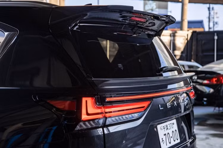 Phía đầu xe, Lexus LX600 độ Liberty Walk vẫn sử dụng thanh tản nhiệt nằm ngang đặc trưng nhưng được sơn lại thành màu đen bóng thay vì màu bạc như trước. Phần nắp capo được hãng độ nước Nhật nâng cấp thêm các khe thoát gió.