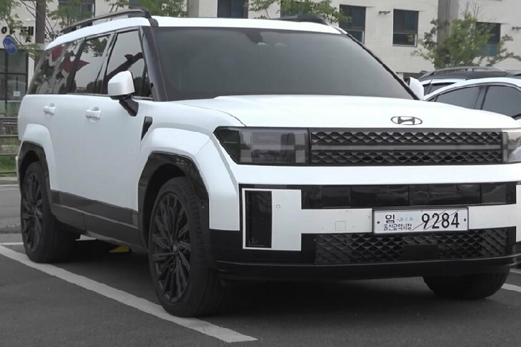 Logo của hãng Hyundai không còn nằm trong lưới tản nhiệt như thế hệ cũ mà chuyển lên nắp ca-pô. Ngoài ra, Hyundai SantaFe 2024 còn có khe gió nằm dọc ở hai góc đầu xe, hốc gió trung tâm rộng trên cản trước, sườn xe khá thẳng thớm, hốc bánh góc cạnh, kính cửa sổ rộng và có thiết kế chia khoang độc đáo, baga nóc mới, cửa cốp bằng phẳng, thẳng đứng, đèn hậu đặt thấp cũng như 1 đầu ống xả dưới cản sau.