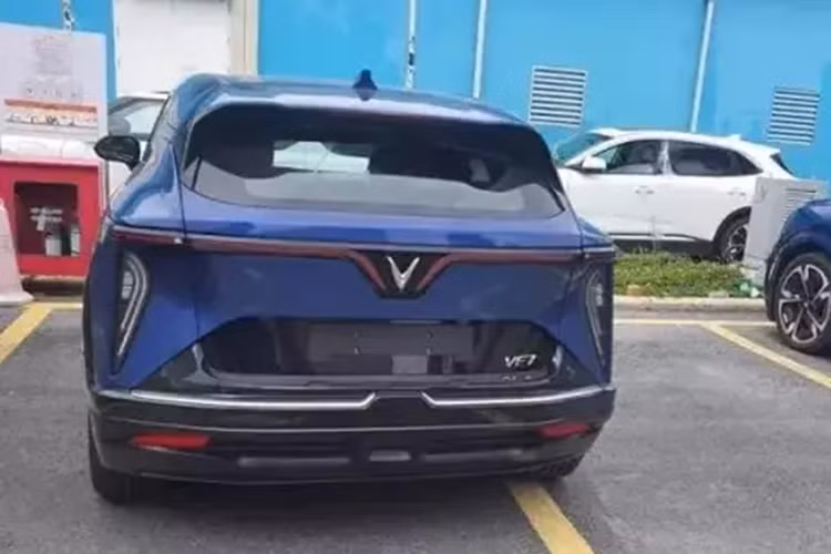 Trong khi đó, logo VF7 được chuyển sang vị trí cách xa hơn so với khu vực lắp biển số sau. Tiếp đến là bộ vành hợp kim 5 chấu được sơn màu đen thay vì bạc. Tương tự xe concept, VinFast VF7 bản thương mại sẽ được trang bị dải đèn hình cánh chim đặc trưng trên đầu và đuôi xe.