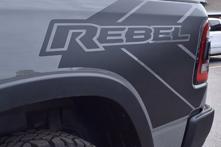 Ở phiên bản RAM 1500 Rebel mới này, các chi tiết mạ crom đã được lược bỏ hoàn toàn và thay vào đó là lớp sơn đen mờ. Bộ mâm 6 chấu 18 inch đơn giản kết hợp lốp đi địa hình thương hiệu Goodyear.