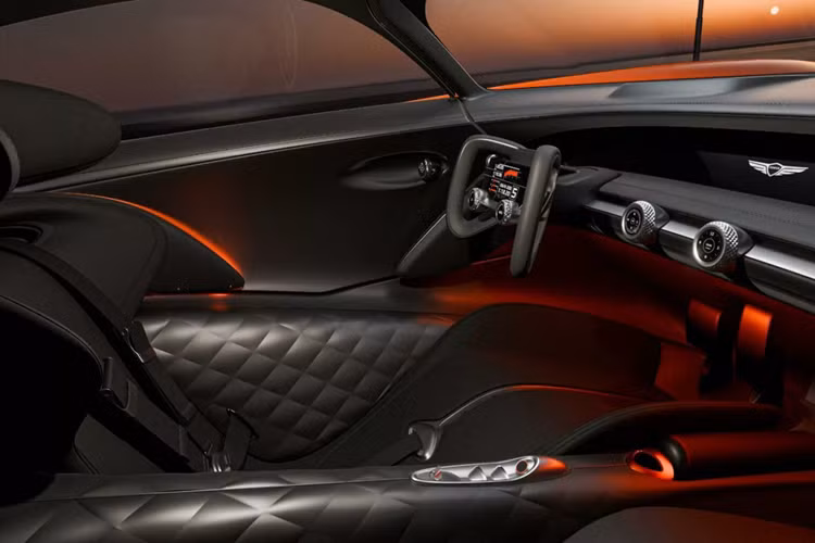 Dải đèn Quad Lights đặc trưng của Genesis bao quanh lưới tản nhiệt Crest và trải dài ra phía sau qua hết bộ mâm kiểu khóa trung tâm. Phần đuôi xe nổi bật với thiết kế hình elip độc đáo, đèn hậu cong mềm mại, phía dưới là bộ khuếch tán gió cỡ lớn, đi kèm đèn phanh kiểu F1.