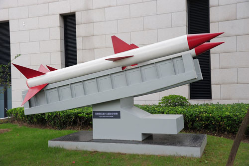 Trong ảnh là tên lửa Hồng Kỳ 61 nằm trong bảo tàng hải quân của Trung Quốc đặt ở Thượng Hải. Theo Zh.wikipedia, Hồng Kỳ 61 là tên lửa phòng không tầm gần của Hải quân Trung Quốc, được bắt đầu nghiên cứu từ năm 1965 và được trang bị trong thập niên 1970 cho các hộ vệ hạm lớp 053K để thực nghiệm. Đến thập niên 1980 mới chính thức trang bị đại trà. Tên lửa dài 3,99m, đường kính 0,286m, sải cánh 1,166m. Nó bắn tới độ cao 8.000m, tầm bắn hiệu quả 2.500 đến 10.000m.