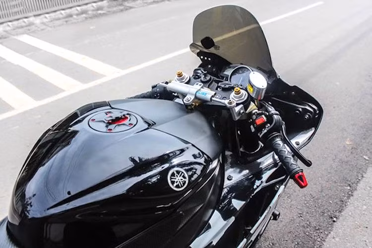 Ở phía trên khu vực tay lái, chiếc xe cũng đã được lắp kính chắn gió Sport Touring của Zero Gravity, bên dưới là trợ lực Ohlins với pát Hyperpro cùng nắp xăng CNC và bộ dán chống trượt bình xăng của Techspec.