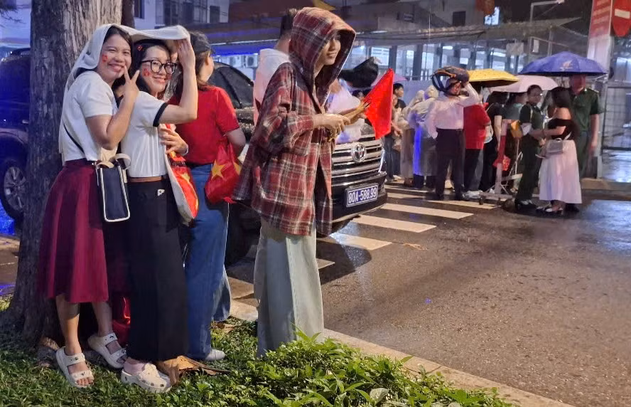 Cơn mưa bất chợt cũng không làm giảm đi sự nhiệt tình của người dân