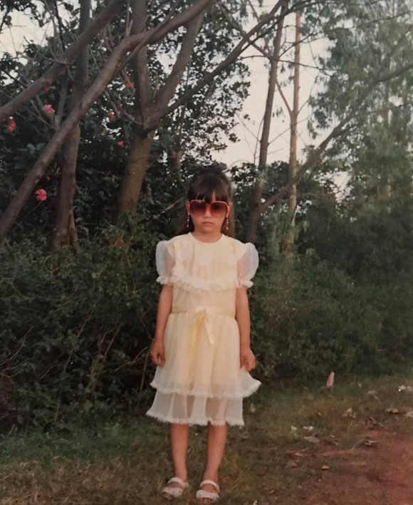 Chia sẻ bức ảnh thời nhỏ đậm chất "thần thái" và sành điệu, Hồ Ngọc Hà còn phải thốt lên: "Đừng nhìn em nữa. Em của ngày xưa hú hồn. Ngày xưa đã biết mái mưa, buộc nửa đầu mắt kính to, váy chiết eo. Nom cũng được các bác nhỉ, mặt hơi khó chịu thôi". Ảnh: FBNV.