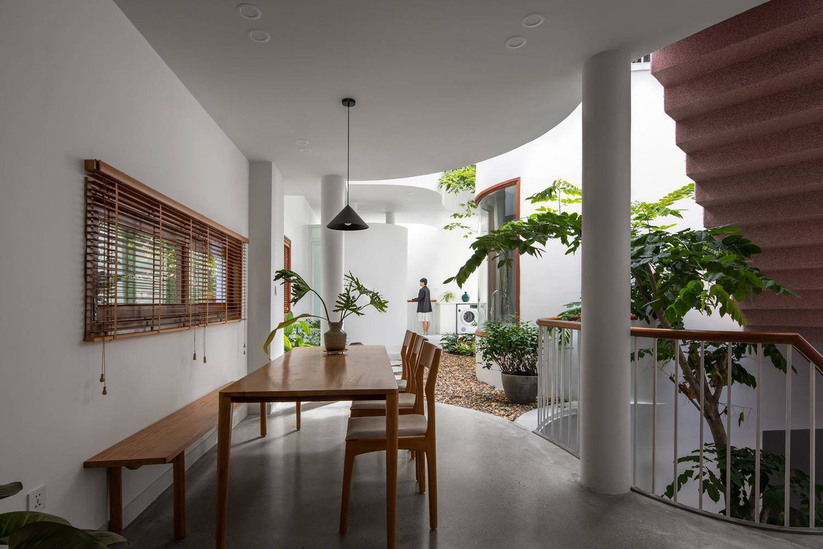 Bàn ăn bên cạnh bếp có thể nhìn ra khoảng giếng trời giữa nhà.