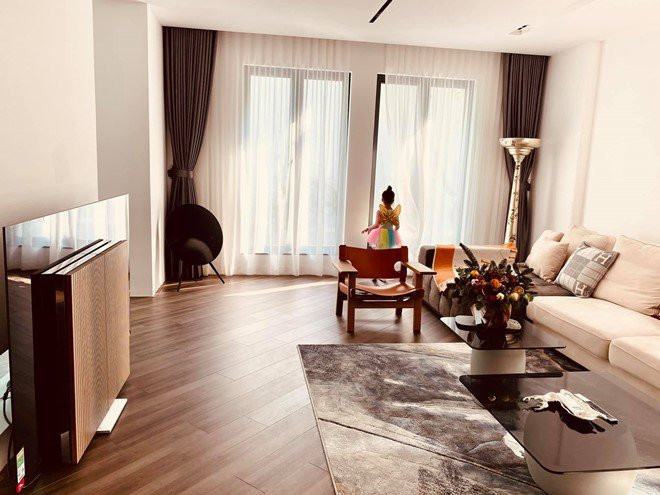 Căn phòng rộng rãi có 2 ô cửa lớn. Biên tập viên nhà đài sử dụng tường, rèm màu sáng kết hợp nội thất màu nâu tôn lên vẻ sang trọng, tối giản.