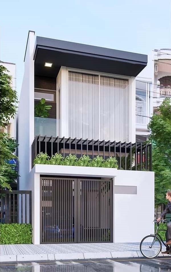 Ngôi nhà 2 tầng được thiết kế với những hình khối đơn giản kết hợp gam màu tươi sáng. Thiết kế cửa kính lớn ở tầng 2 cùng lô gia nhỏ, thay thế hoàn hảo cho ban công, giúp tiết kiệm không gian sống hiệu quả. Ảnh: Wedo