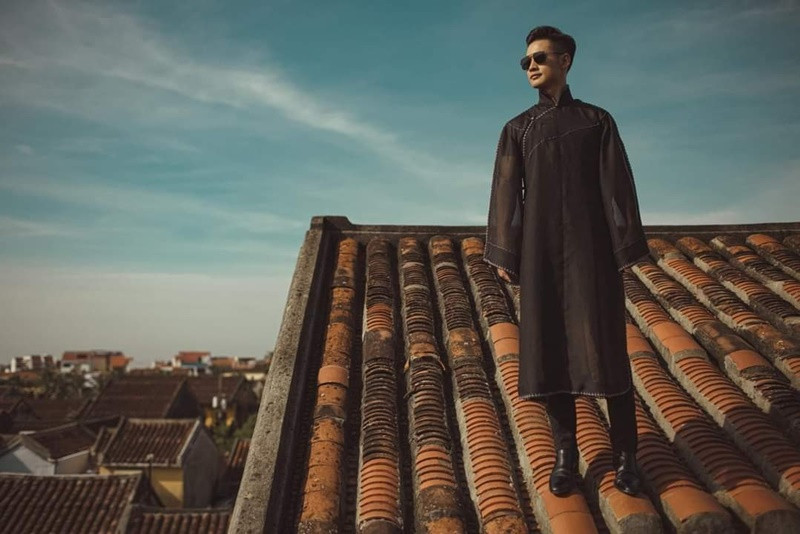 Hình ảnh ca sĩ Đức Tuấn đứng trên mái nhà cổ ở Hội An chụp ảnh khiến dư luận rất bức xúc. Ảnh: FBNV.