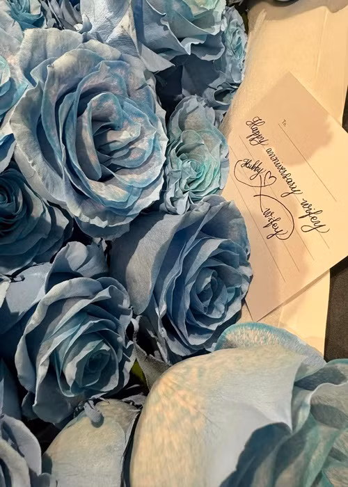 Cô nhận hoa và thiệp chúc mừng ngày kỷ niệm từ bạn đời.