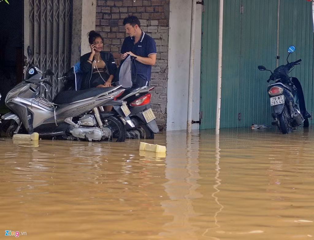 Du khách nước ngoài ngồi chờ nước rút trong chiều 13/12.