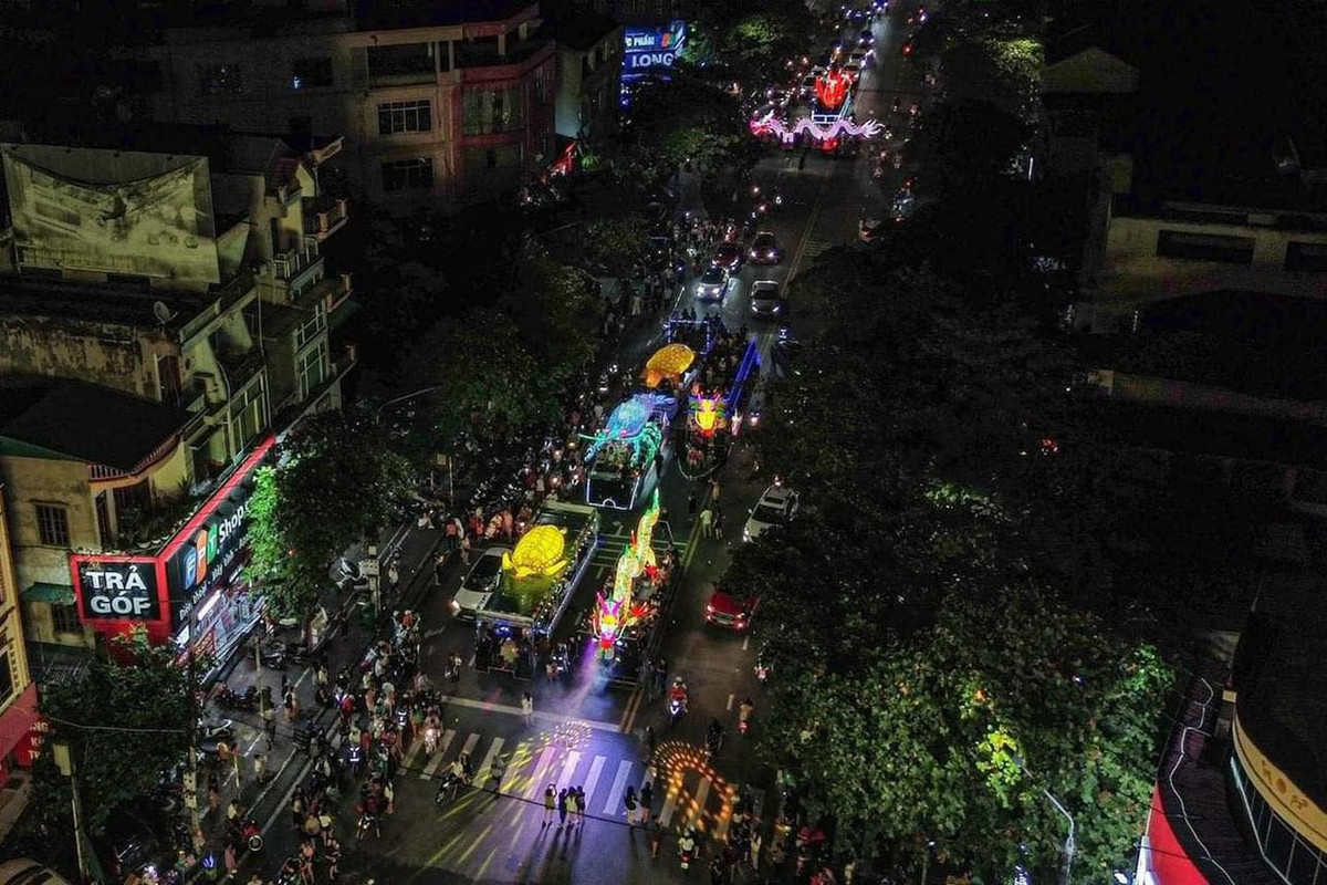 Trên các mô hình đèn trung thu khổng lồ, người lớn và trẻ em ngồi quây kín, cùng nhau reo hò. (Ảnh: Dương Duy/Nhiếp Ảnh Dương)