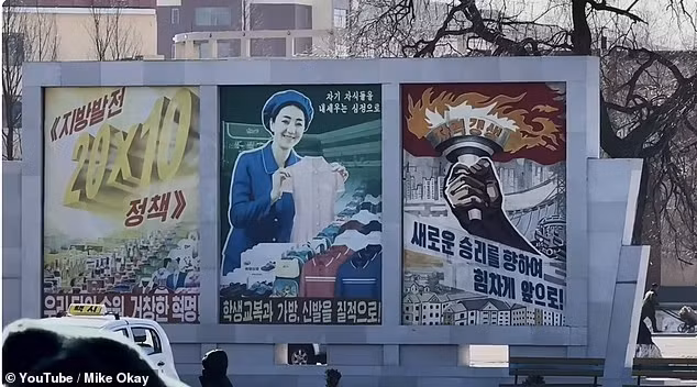 Đường phố tại các thị trấn có rất nhiều áp phích tuyên truyền về hoạt động sản xuất. Ảnh: YouTube/Mike Okay.