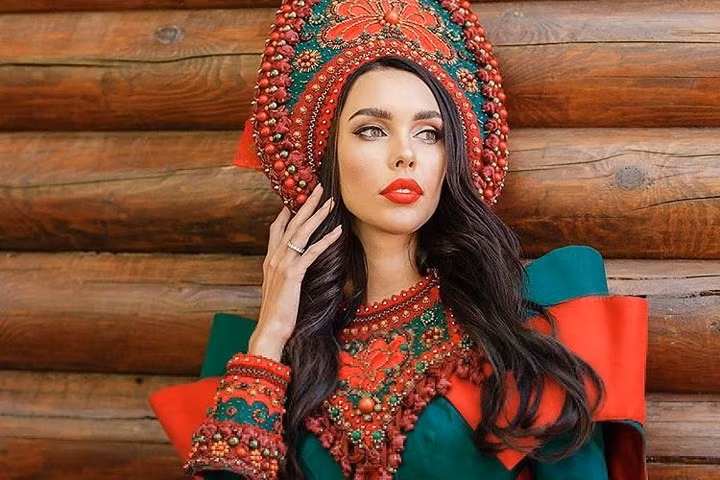 Tsaritsina trong trang phục truyền thống của phụ nữ Nga bên nhà gỗ. Cô cho biết, mình rất ngỡ ngàng trước việc mình đoạt giải Mrs World Nga.