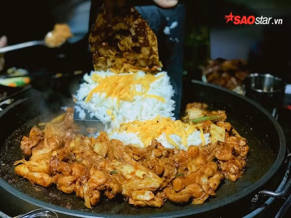 Hương thơm lừng tỏa ra từ chiếc chảo ngập tràn thức ăn khiến thực khách phải thòm thèm. Mặc dù thành phần chính là gà nhưng nét đặc sắc của món Dakgalbi cũng phải “nhờ công” của các thức ăn kèm được xào cùng. Khoai lang béo bùi, bắp cải giòn tươi, củ hành tiếp thêm vị thơm nồng… tất cả hòa quyện vào nhau chiếm trọn mọi cung bậc vị giác. Món ăn còn được cho vào thêm những miếng bánh gạo dẻo thơm để tăng thêm độ ngọt dai hấp dẫn.