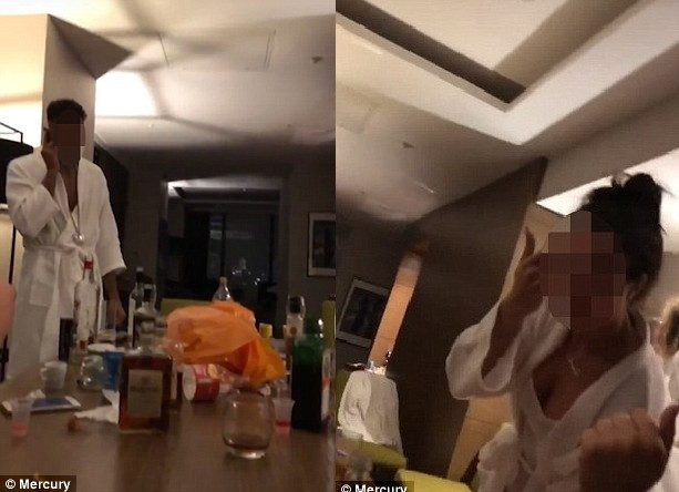 Ảnh cắt từ video quay trong khách sạn Hilton cho thấy các cô gái và chàng trai nhảy nhót quanh một chiếc bàn đầy rượu.