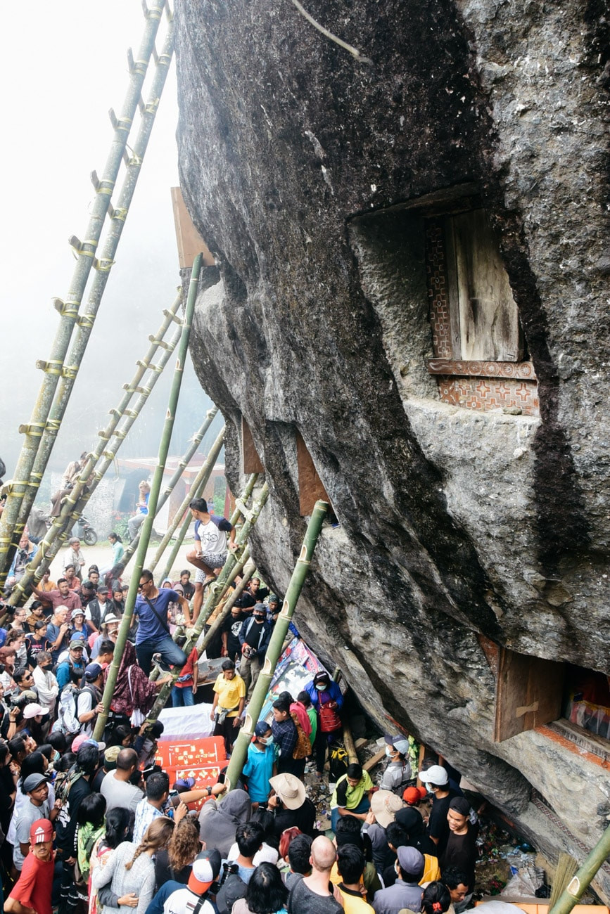 Người xem nghi lễ vây kín quanh hang động, nơi lưu giữ những ngôi mộ đá. Có những ngôi mộ đã tồn tại hàng trăm năm.