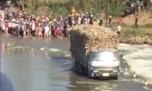 Chiếc xe tải bị kẹt trong dòng nước lũ. Ảnh: Hữu Phúc