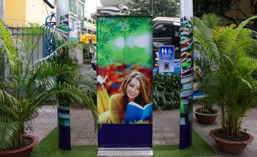 Còn đây là nhà vệ sinh công cộng được thiết kế khá gần gũi thiên nhiên, và miễn phí đặt trên vỉa hè đường Nguyễn Du (quận 1, TP. HCM). Diện tích cabin vệ sinh công cộng này khoảng 2,2m vuông, có kiểu dáng khối vuông bốn góc bo tròn. Nóc cabin vệ sinh được gắn hệ thống pin năng lượng mặt trời.