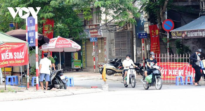 Một chốt kiểm soát khác thuộc Tân Mai, Hoàng Mai, mặc dù có lực lượng chức năng nhưng người và phương tiện vẫn vào ra bình thường. Điều đáng nói, người dân không tuân thủ quy định an toàn giao thông khi không đội mũ bảo hiểm.