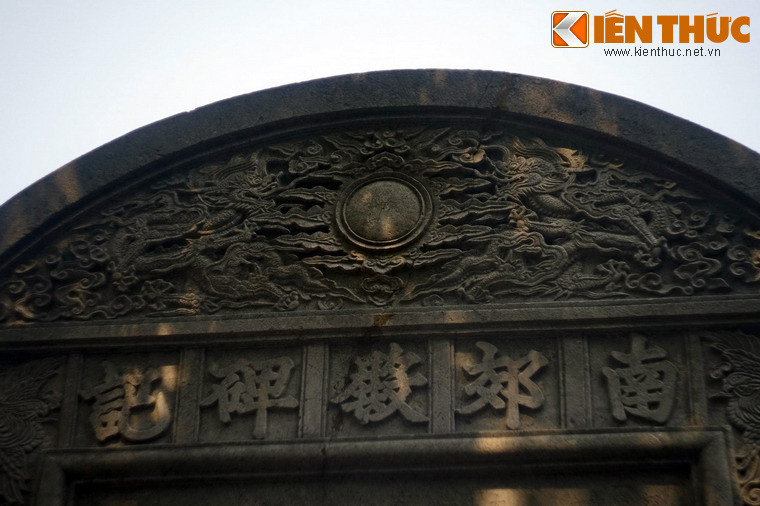 Diềm trán bia chạm khắc đề tài lưỡng long chầu nguyệt và mây.