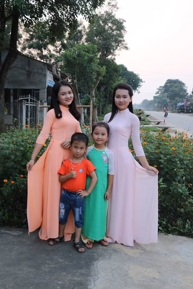 Cô gái mặc áo dài màu hồng còn lại là em gái thứ hai của Thu, năm nay 19 tuổi. Dưới hai chị em còn có cậu em trai 6 tuổi và cô em gái nhỏ 9 tuổi.