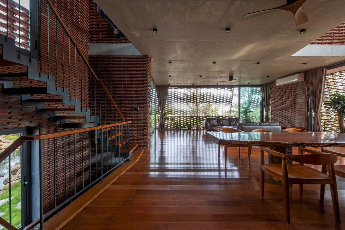 Phòng khách và bếp bố trí thông nhau, phần lớn sử dụng nội thất gỗ. Ảnh: Lê Minh Hoàng