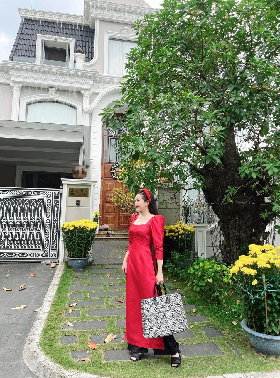 Phía trước ngôi nhà là không gian thoáng đãng, trồng nhiều cây xanh và hoa tươi.