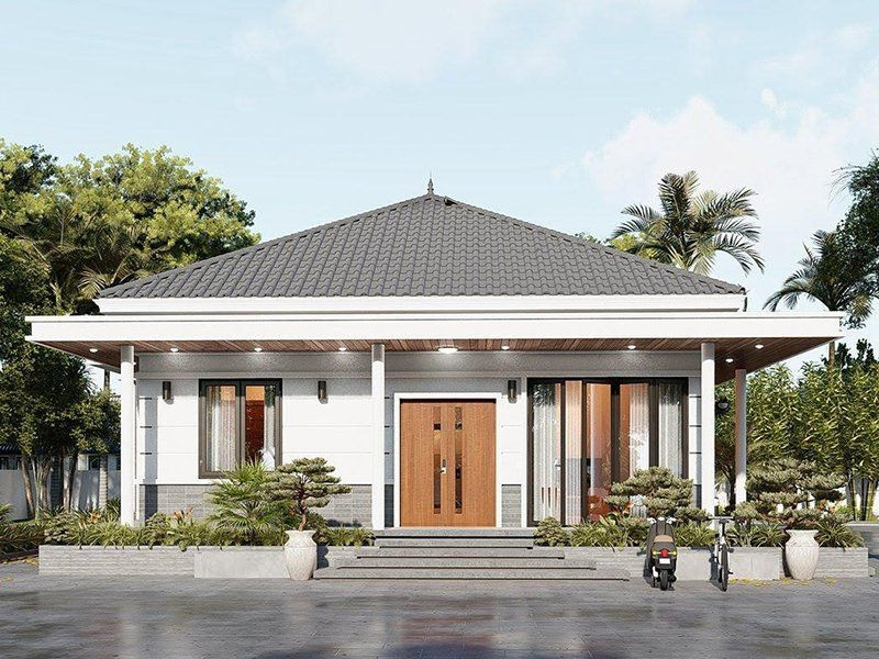 Mẫu nhà mái Nhật 1 tầng sử dụng hệ thống cửa kính cường lực trẻ trung, hiện đại. Tường ngoài ốp lớp gạch xám mộc giản dị. Ảnh: Xaynhadeponline