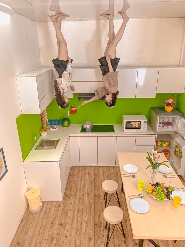 Phòng bếp nổi bật với miếng dàn tường màu xanh lục trên nền trắng.