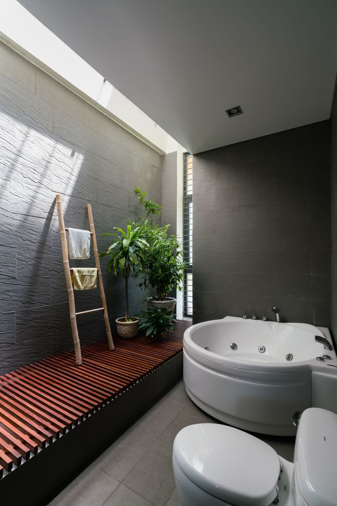 Tường nhà được ốp bằng xi măng và đá tự nhiên ở khu vực trống. Ảnh: Quang Đàm