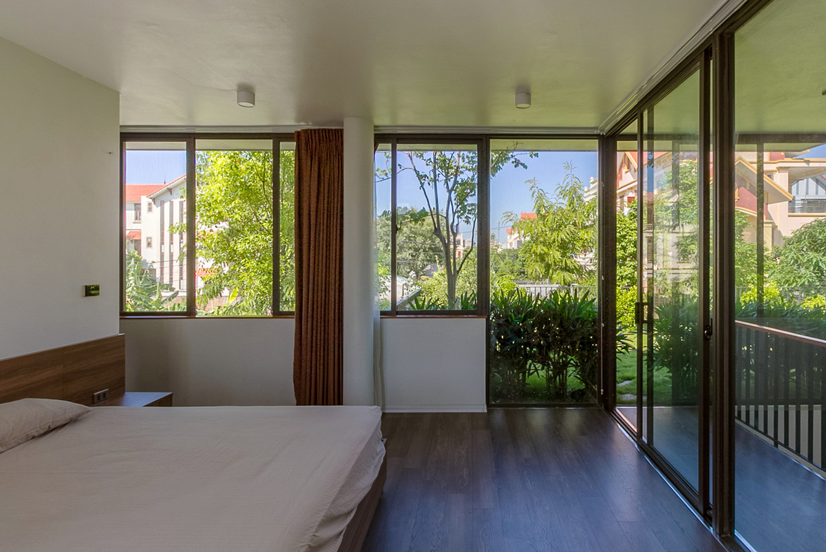 Phòng ngủ thư thái và trong lành hơn nhờ khu vườn xanh bên cạnh. Ảnh: HGAA