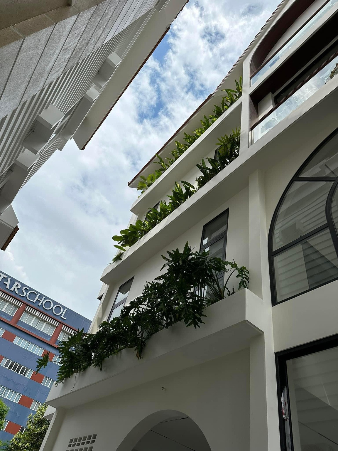 Biệt thự của vợ chồng Vân Trang có gam màu trắng chủ đạo, được tô điểm bởi nhiều cây xanh. Ảnh: FB Vân Trang