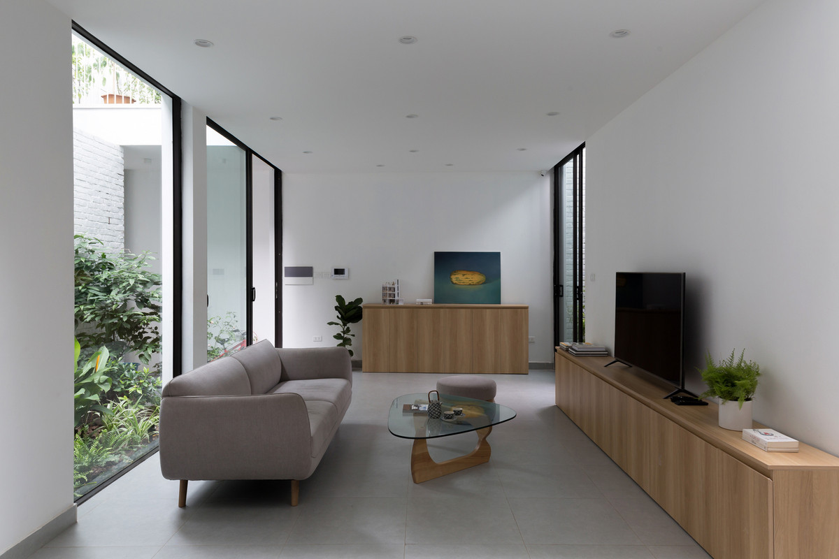 Tầng trệt gồm phòng khách – phòng ăn – bếp. Ảnh: HGAA