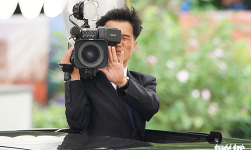 Nhân viên phụ trách ghi hình chuyến đi của ông Kim Jong Un quay phim trên nóc xe suốt hành trình - Ảnh: THUẬN THẮNG Nhân viên phụ trách ghi hình chuyến đi của ông Kim Jong Un quay phim trên nóc xe suốt hành trình - Ảnh: THUẬN THẮNG