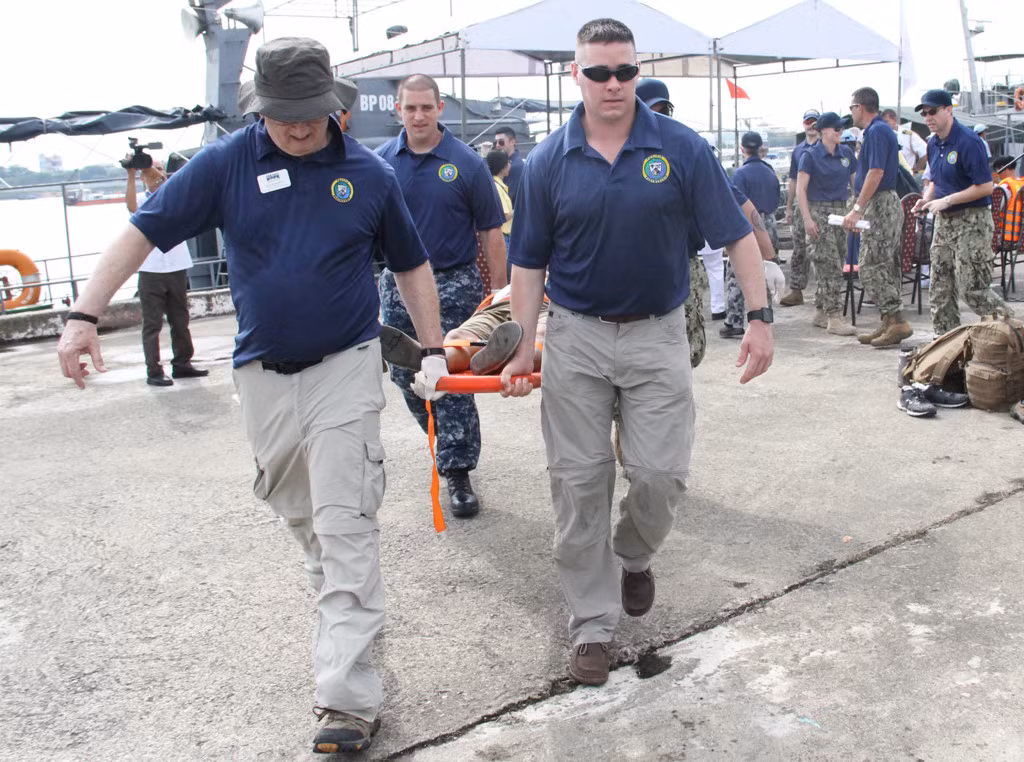 ... sau đó nhanh chóng đưa các thuyền viên trên con tàu chở dầu ra xe cứu thương để chuyển đến bệnh viện điều trị.
