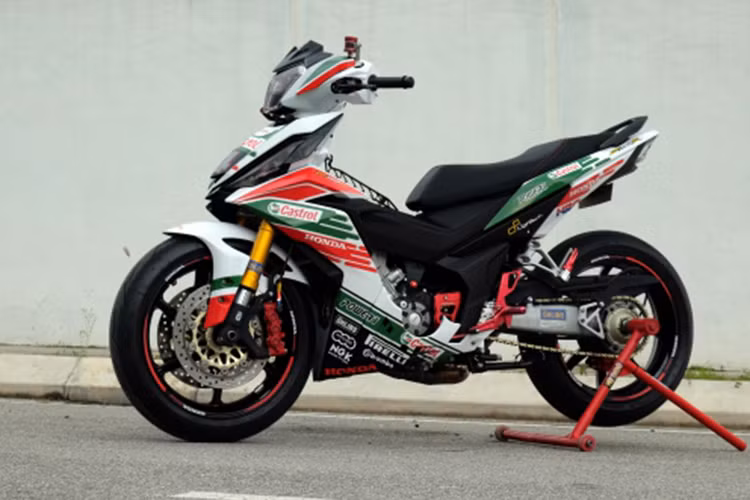 Điểm nhấn đầu tiên của chiếc Honda Winner 150 độ này chính là bộ cánh Castrol với ba màu chủ đảo đỏ xanh và trắng nổi bật. Chiếc xe underbone gọn gàng ban đầu được thổi lên thành ngoại hình đầy mạnh mẽ.