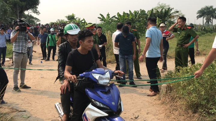 Rất đông người dân cùng phóng viên có mặt tại khu vực hiện trường để theo dõi 2 nghi phạm diễn lại hành vi phạm tội. Khu vực tại hiện trường là nơi vắng vẻ, xa khu dân cư.