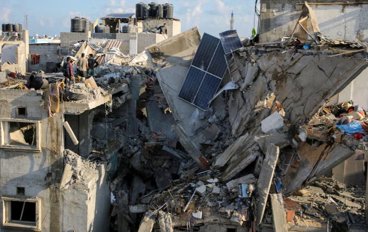 Người dân Palestine kiểm tra ngôi nhà bị hư hại ở Rafah.