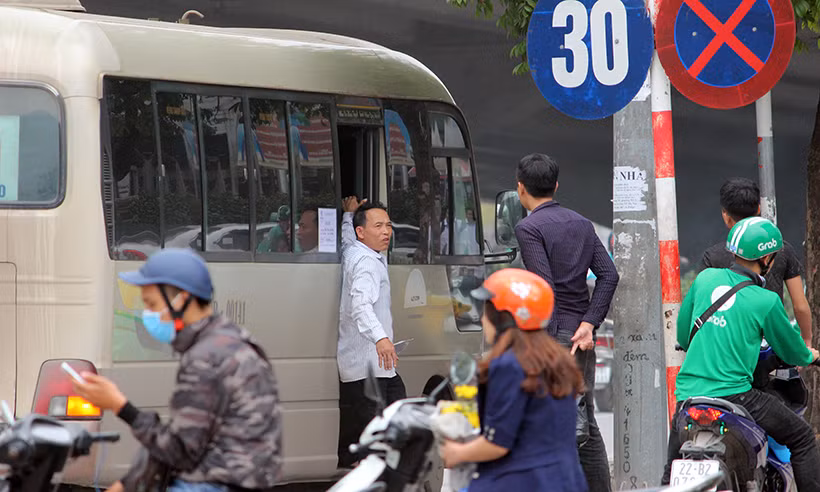 Phụ xe mở cửa nài nỉ hành khách lên xe.