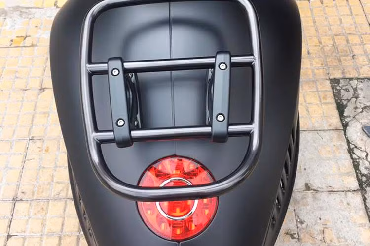 Vespa 946 Emporio Armani còn được trang bị giá đỡ và thùng đồ màu nâu cao cấp phía sau. Yên xe dạng đôi có thể tháo rời thành yên mono.