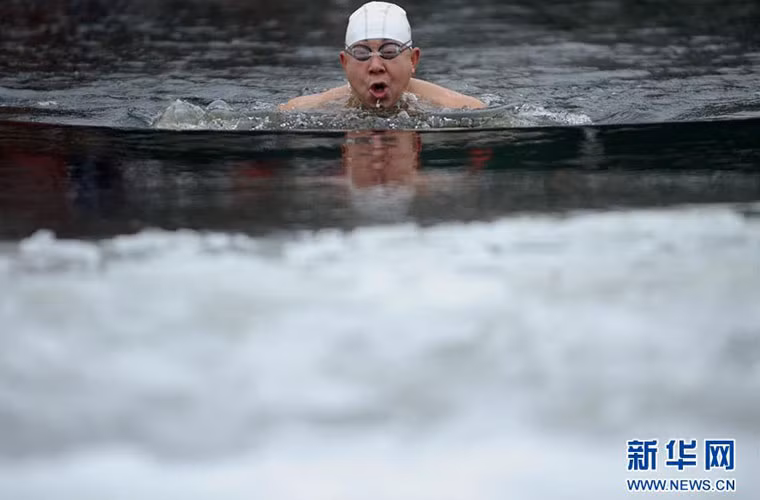 Người đàn ông đang bơi giữa dòng nước đóng băng vào một ngày đông giá rét.