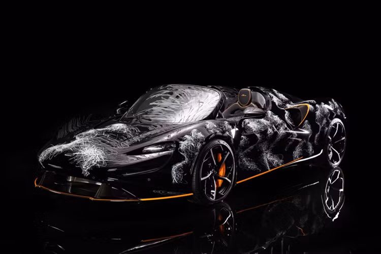 Chiếc McLaren Elva của doanh nhân ngành nhựa sở hữu “bộ cánh” màu đen ánh kim, cùng đường viền cam ở cản trước, bên hông và khe gió làm điểm nhấn. Điểm ấn tượng nhất của siêu xe Anh Quốc này là tác phẩm nghệ thuật mang tên "Icare" được vẽ trực tiếp lên thân bởi họa sĩ Hom Nguyen và lấy cảm hứng từ thần thoại Hy Lạp Icarus.