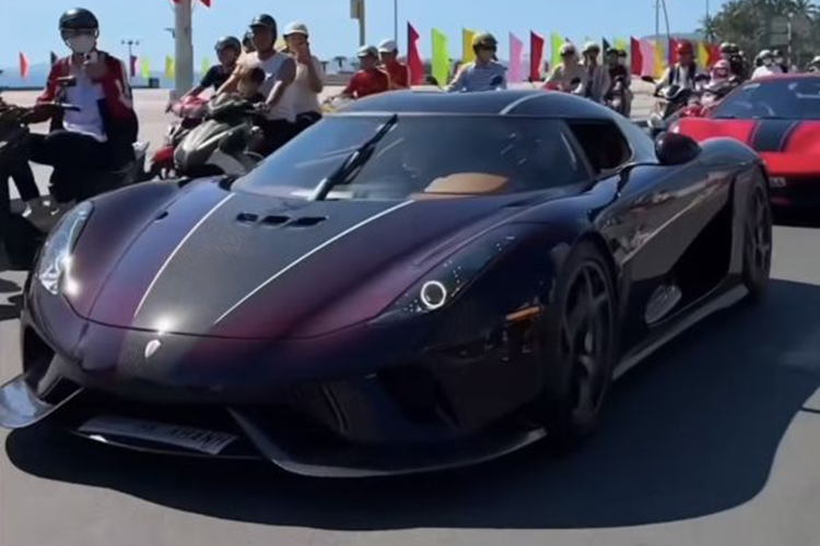 Được biết, chiếc Koenigsegg Regera của Hoàng Kim Khánh được vận chuyển bằng xe chuyên dụng từ TP.HCM đến Nha Trang. Khi chuẩn bị khui thùng để đưa xe ra, hàng trăm người dân đã đứng đó, mong ngóng được tận mắt chiêm ngưỡng siêu phẩm hai trăm tỷ này.