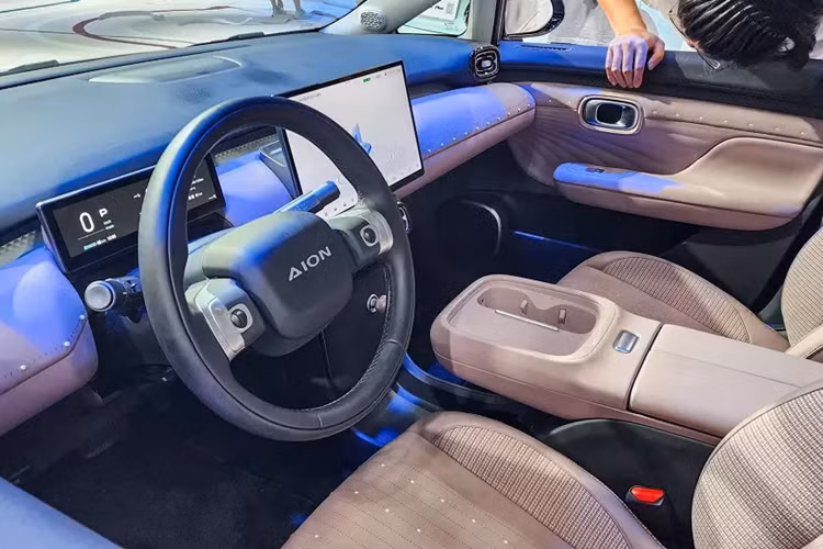 Tùy theo phiên bản, xe sẽ dùng vành có đường kính 16 inch hoặc 17 inch. Bên trong Aion UT là không gian nội thất 5 chỗ ngồi khá rộng rãi nhờ chiều dài cơ sở lớn. Trước mặt người lái là vô lăng 2 chấu hình tròn, tích hợp hai con lăn chỉnh một số tính năng của xe, và bảng đồng hồ kỹ thuật số 8,8 inch.