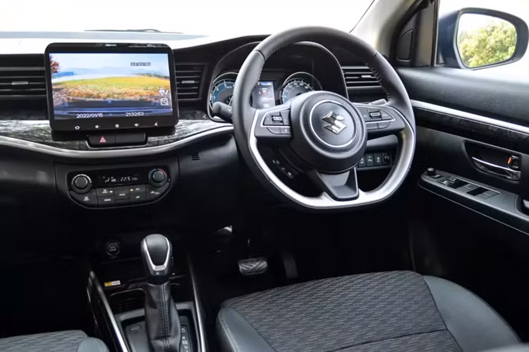 Màu sơn ngoại thất be kết hợp với nóc đen cũng là điểm mới của mẫu MPV này. Ngoài ra, xe còn có 5 màu sơn khác là cam - nóc đen, trắng ngọc trai - nóc đen, trắng - nóc đen, xám, đen và trắng ngọc trai. Bên trong xe, Suzuki XL7 Hybrid 2024 tại Thái Lan sở hữu bảng đồng hồ mới với màn hình màu 4,2 inch ở giữa, hiển thị thông tin về dung lượng pin.