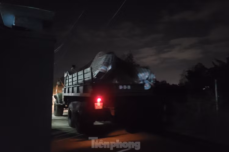 Xe quân đội liên tục chở các thiết bị, mảnh vỡ từ máy bay ra khỏi khu dân cư trong đêm. (Ảnh: Giang Thanh).