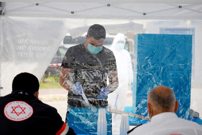 Được biết, Ủy ban Bầu cử Israel đã thiết lập những điểm bỏ phiếu đặc biệt để những người dân Israel đang bị cách ly vì dịch COVID-19 vẫn có thể đi bỏ phiếu. Ảnh: Một cử tri đeo khẩu trang và găng tay đi bỏ phiếu tại Ashkelon ngày 2/3.