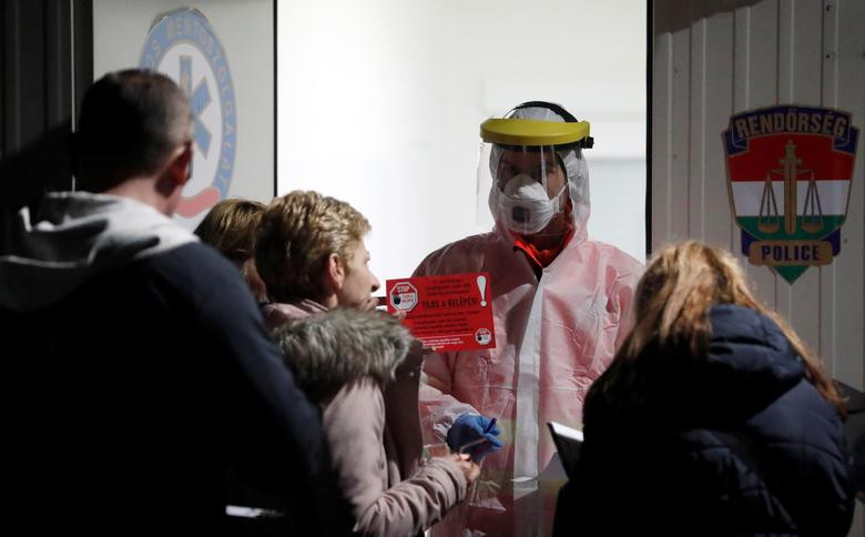 Một y tá mặc đồ bảo hộ trao đổi với du khách tại lối đi đặc biệt được mở để giúp mọi người qua biên giới Hungary-Áo, tại Hegyeshalom, Hungary, ngày 17/3.